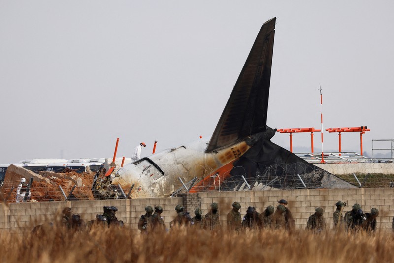 This aerial photo show the burn-out Japan Airlines plane at Haneda airport on Wednesday, Jan. 3, 2024, in Tokyo, Japan. The large passenger plane and a Japanese coast guard aircraft collided on the runway at Tokyo's Haneda Airport on Tuesday and burst into flames, killing several people aboard the coast guard plane, officials said. (Kyodo News via AP)