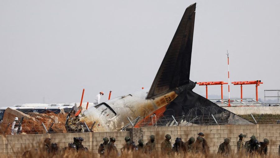 This aerial photo show the burn-out Japan Airlines plane at Haneda airport on Wednesday, Jan. 3, 2024, in Tokyo, Japan. The large passenger plane and a Japanese coast guard aircraft collided on the runway at Tokyo's Haneda Airport on Tuesday and burst into flames, killing several people aboard the coast guard plane, officials said. (Kyodo News via AP)