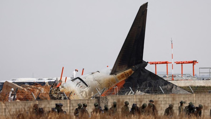 This aerial photo show the burn-out Japan Airlines plane at Haneda airport on Wednesday, Jan. 3, 2024, in Tokyo, Japan. The large passenger plane and a Japanese coast guard aircraft collided on the runway at Tokyo's Haneda Airport on Tuesday and burst into flames, killing several people aboard the coast guard plane, officials said. (Kyodo News via AP)