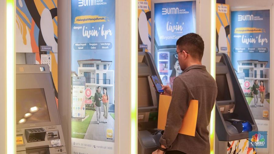 Sejumlah orang melakukan transaksi melalui mesin Anjungan Tunai Mandiri (ATM) di Bank Mandiri. (CNBC Indonesia/Faisal Rahman)