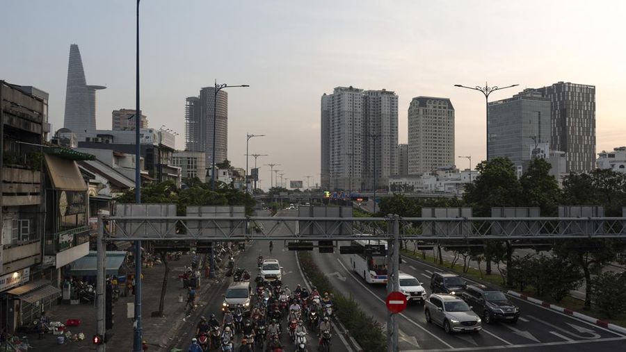 Para penumpang skuter dan pengendara mobil menunggu lampu lalu lintas berubah di persimpangan selama jam sibuk pagi di Kota Ho Chi Minh, Vietnam, Jumat, 12 Januari 2024. (AP Photo/Jae C. Hong/File Foto)