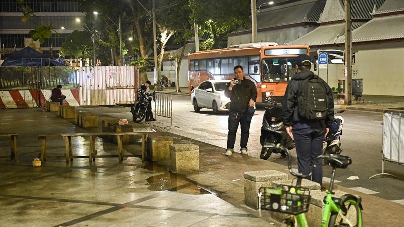 Anggota Biro Investigasi Pusat (CIB) berdiri di dekat tempat mantan anggota parlemen Kamboja dilaporkan ditembak, di Bangkok pada 7 Januari 2025. Seorang mantan anggota parlemen oposisi Kamboja ditembak mati oleh seorang pria bersenjata yang mengendarai sepeda motor di Bangkok pada 7 Januari, media Thailand melaporkan. (Photo by Lillian SUWANRUMPHA / AFP)