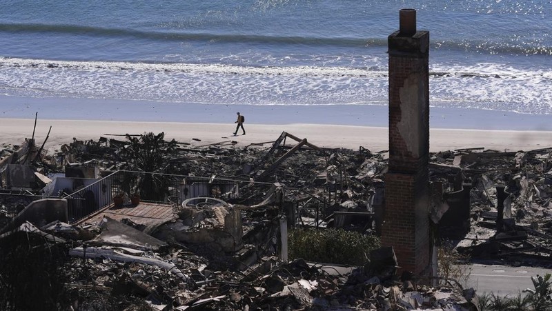 Rumah-rumah yang hancur akibat Kebakaran Palisades di sepanjang Pacific Coast Highway di Malibu, California, Minggu (12/1/2024). (AP Photo/Mark J. Terrill)