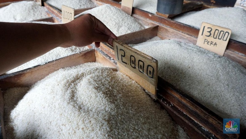 Pekerja menata beras di toko eceran beras di Kawasan Menteng Pulo, Jakarta, Selasa (14/1/2025). (CNBC Indonesia/Muhammad Sabki)