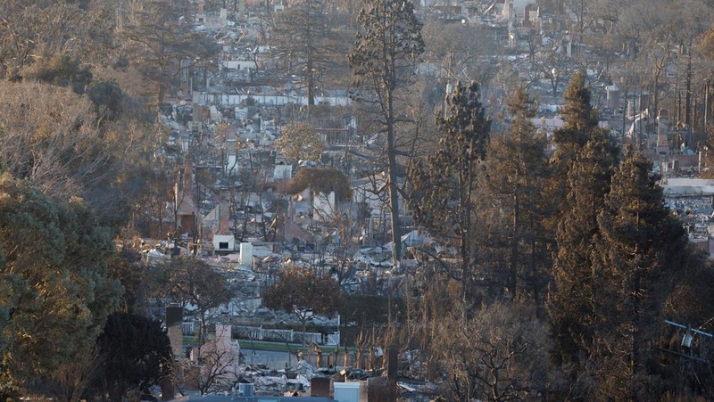 Sisa-sisa mobil rumah yang terbakar tergeletak di tanah, setelah angin kencang yang memicu kebakaran hutan yang dahsyat di wilayah Los Angeles memaksa orang-orang untuk mengungsi, di lingkungan Pacific Palisades di sisi barat Los Angeles, California, AS, 13 Januari 2025. (REUTERS/Daniel Cole)