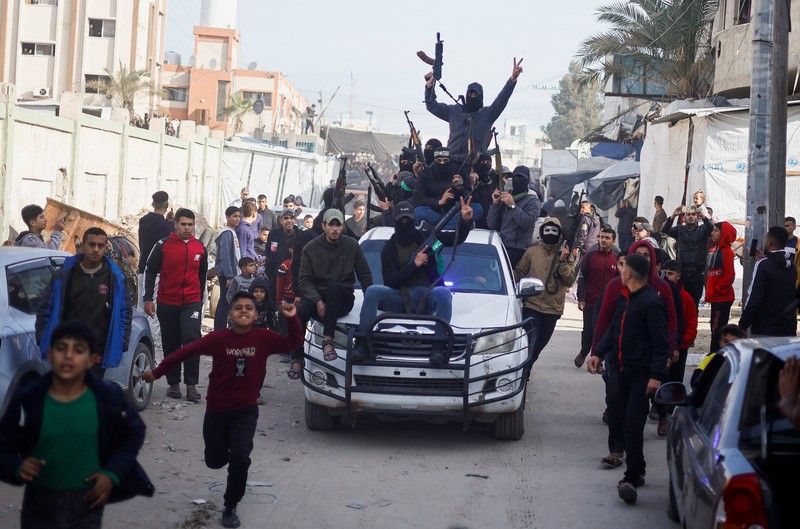 Militan Palestina merayakan meskipun ada penundaan gencatan senjata antara Israel dan Hamas mengenai daftar sandera, di Khan Younis di Jalur Gaza selatan, 19 Januari 2025. Militan Palestina merayakan meskipun ada penundaan gencatan senjata antara Israel dan Hamas mengenai daftar sandera, di Khan Younis di Jalur Gaza selatan, 19 Januari 2025. (REUTERS/Mohammed Salem)
