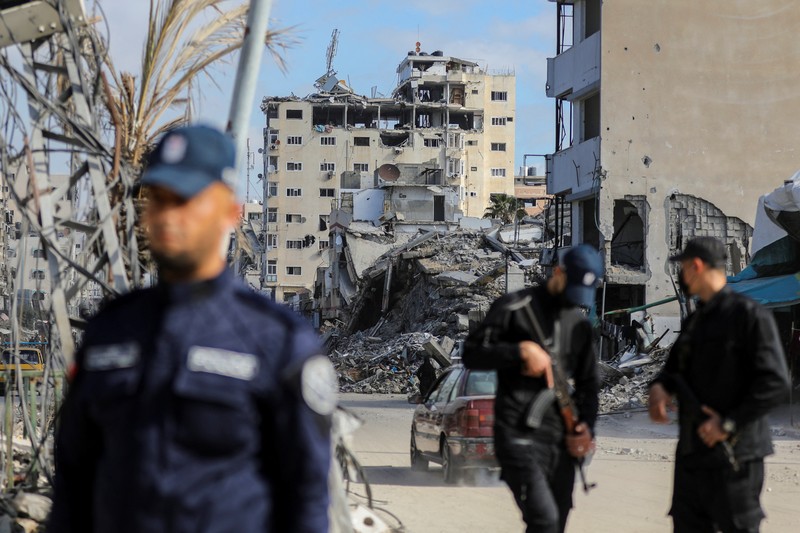 ISRAEL-PALESTINIANS/GAZA-CEASEFIRE-HAMAS-POLICE Palestinian Hamas policemen stand guard near the rubble after deploying in streets to maintain order, following a ceasefire between Israel and Hamas, in Gaza City, January 20, 2025. REUTERS/Dawoud Abu Alkas