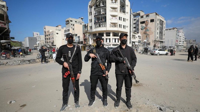 Palestinian Hamas policemen stand guard near the rubble after deploying in streets to maintain order, following a ceasefire between Israel and Hamas, in Gaza City, January 20, 2025. REUTERS/Dawoud Abu Alkas