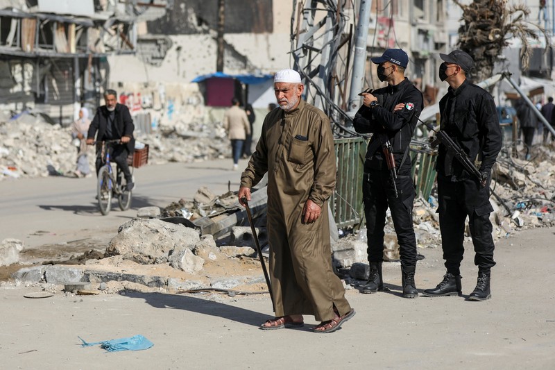 Palestinian Hamas policemen stand guard near the rubble after deploying in streets to maintain order, following a ceasefire between Israel and Hamas, in Gaza City, January 20, 2025. REUTERS/Dawoud Abu Alkas