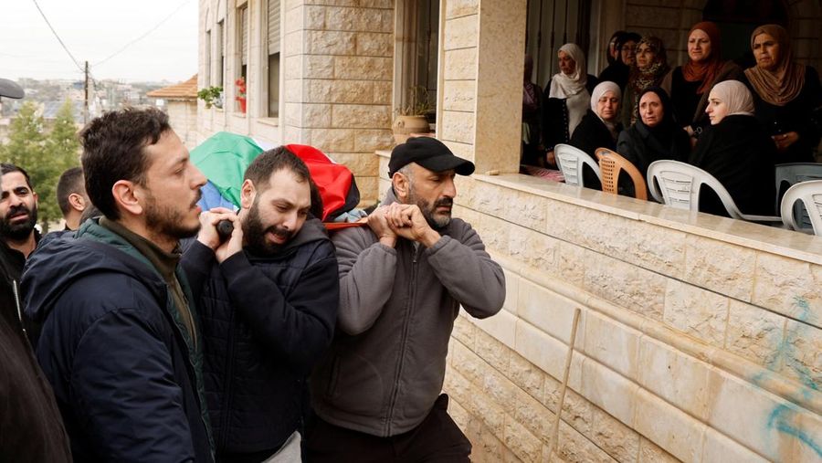 SENSITIVE MATERIAL. THIS IMAGE MAY OFFEND OR DISTURB    Mourners carry the body of Ahmed Shayeb, a Palestinian father who was killed during an Israeli raid in Jenin, during his funeral in Burqin, in the Israeli-occupied West Bank, January 22, 2025. REUTERS/Raneen Sawafta