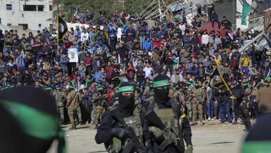 Israel Palestinians A crowd watches as Hamas and Islamic Jihad fighters deploy in central Gaza City ahead of the planned release of four Israeli female soldier hostages set to be handed over to the Red Cross in Gaza City on Saturday, Jan. 25, 2025. (AP Photo/Abed Hajjar)(AP Photo/Abed Hajjar)
