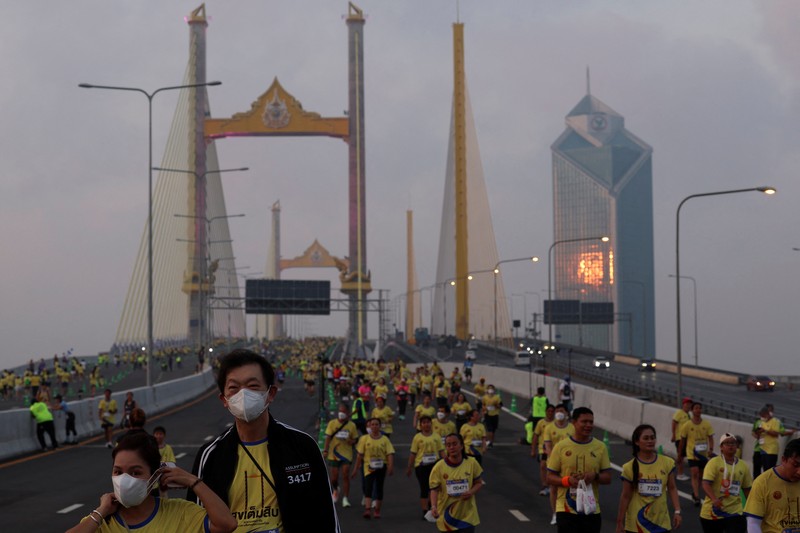 People attend a running event on the newly constructed cable-stayed Rama X Bridge or 