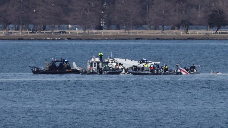 Petugas darurat menemukan puing-puing dari Sungai Potomac setelah tabrakan penerbangan American Eagle 5342 dan helikopter Black Hawk, seperti yang terlihat dari Virginia, AS, 30 Januari 2025. (REUTERS/Carlos Barria)