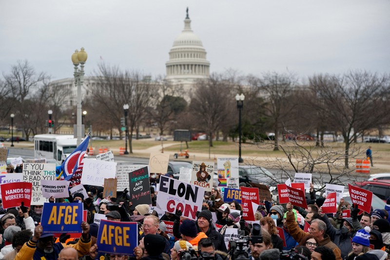 Para demonstran berunjuk rasa selama protes terhadap Presiden AS Donald Trump dan tindakan yang diambilnya pada minggu-minggu pertama masa jabatannya, di luar Departemen Tenaga Kerja (tidak terlihat) di Washington, AS, 5 Februari 2025. Para demonstran berunjuk rasa selama protes terhadap Presiden AS Donald Trump dan tindakan yang diambilnya pada minggu-minggu pertama masa jabatannya, di luar Departemen Tenaga Kerja (tidak terlihat) di Washington, AS, 5 Februari 2025. (REUTERS/Nathan Howard)