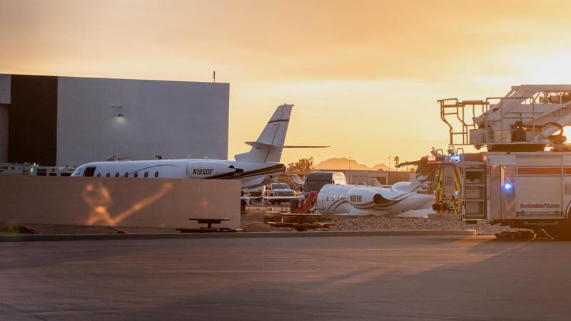 Petugas darurat menanggapi setelah jet bisnis ukuran sedang tergelincir dari landasan saat mendarat dan bertabrakan dengan jet lain yang diparkir di bandara kota di Scottsdale, Arizona, AS, 10 Februari 2025. (REUTERS/Thomas Machowicz)