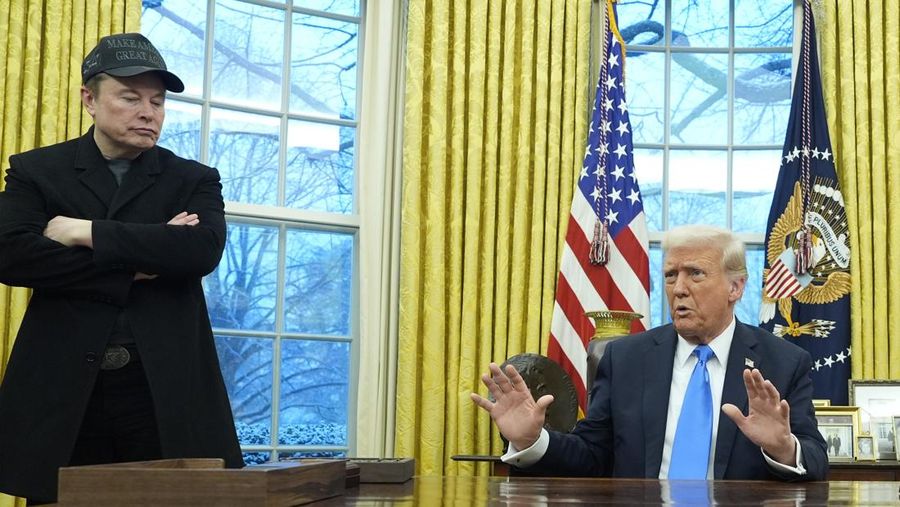 President Donald Trump speaks with reporters as Elon Musk listens in the Oval Office at the White House, Tuesday, Feb. 11, 2025, in Washington. (Photo/Alex Brandon)