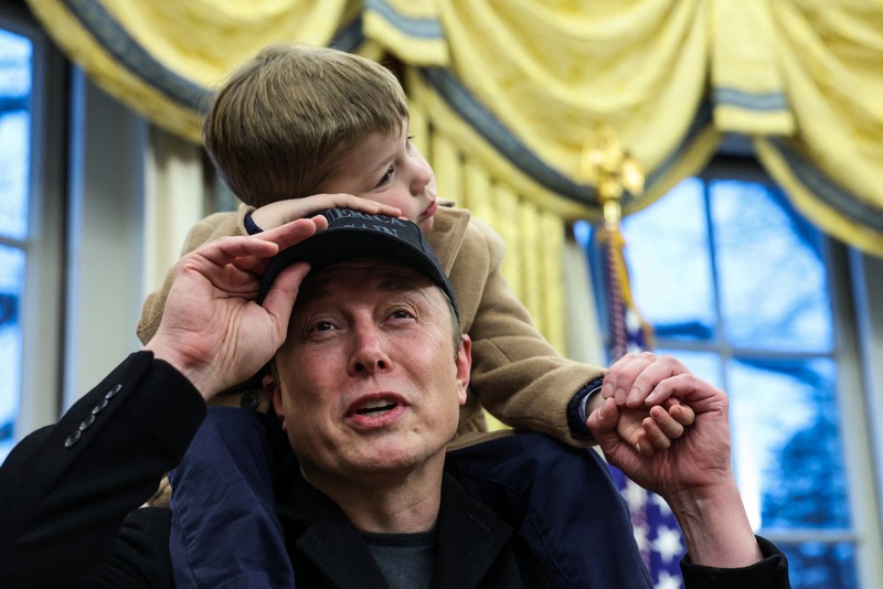 A combination picture shows Elon Musk speaking as he carries his son,  X Æ A-12 on his shoulders, next to U.S. President Donald Trump (not pictured) in the Oval Office of the White House in Washington, D.C., U.S., February 11, 2025.   REUTERS/Kevin Lamarque