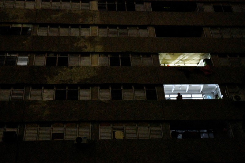 People sit outside their home during a blackout following the failure of a major power plant, Havana, Cuba February 13, 2025. REUTERS/Norlys Perez