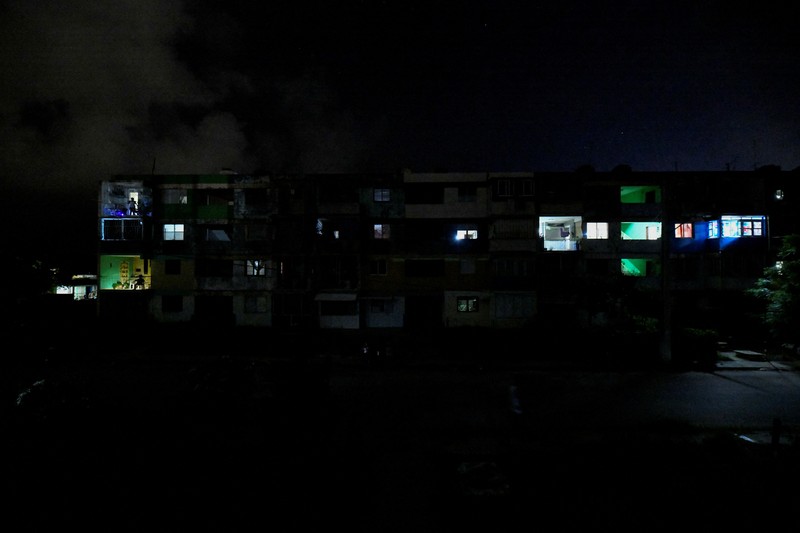 People sit outside their home during a blackout following the failure of a major power plant, Havana, Cuba February 13, 2025. REUTERS/Norlys Perez