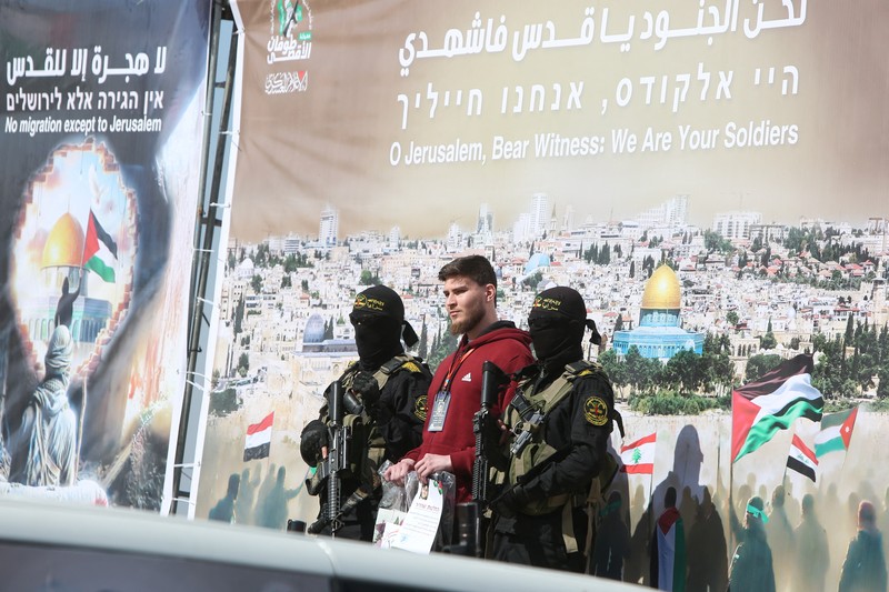 ISRAEL-PALESTINIANS/GAZA-CEASEFIRE A drone view shows Palestinian Hamas and Islamic Jihad militants escorting Iair Horn, U.S.-Israeli Sagui Dekel-Chen and Russian-Israeli Sasha (Alexander) Troufanov, hostages held in Gaza since the deadly October 7, 2023 attack, as they released as part of a ceasefire and a hostages-prisoners swap deal between Hamas and Israel in Khan Younis, in the southern Gaza Strip, February 15, 2025. REUTERS/Stringer