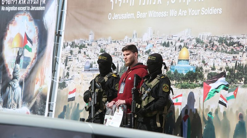 A drone view shows Palestinian Hamas and Islamic Jihad militants escorting Iair Horn, U.S.-Israeli Sagui Dekel-Chen and Russian-Israeli Sasha (Alexander) Troufanov, hostages held in Gaza since the deadly October 7, 2023 attack, as they released as part of a ceasefire and a hostages-prisoners swap deal between Hamas and Israel in Khan Younis, in the southern Gaza Strip, February 15, 2025. REUTERS/Stringer