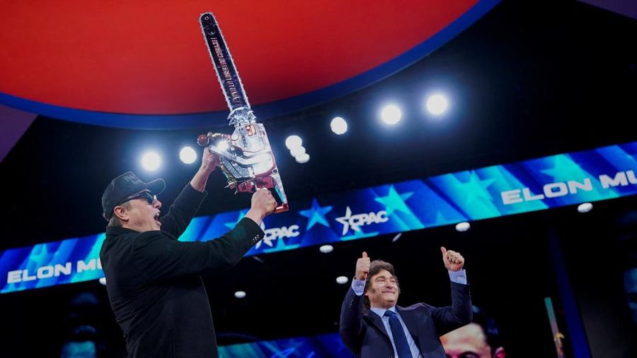 Elon Musk memegang gergaji mesin di atas panggung saat menghadiri Konferensi Aksi Politik Konservatif (CPAC) di National Harbor, Maryland, AS, 20 Februari 2025. (REUTERS/Nathan Howard)