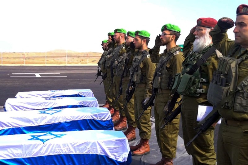 Warga Palestina menyaksikan penyerahan sandera yang telah meninggal, Oded Lifschitz, Shiri Bibas, dan kedua anaknya, Kfir dan Ariel Bibas, yang ditawan dalam serangan mematikan pada 7 Oktober 2023, oleh Hamas kepada Palang Merah sebagai bagian dari gencatan senjata dan kesepakatan pertukaran sandera-tahanan antara Hamas dan Israel, di Khan Younis di Jalur Gaza selatan, 20 Februari 2025. (REUTERS/Ramadan Abed)