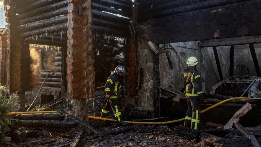 Petugas pemadam kebakaran bekerja di lokasi serangan pesawat nirawak Rusia di wilayah Kyiv, Ukraina, Rabu (26/2/2025). (Handout via REUTERS)