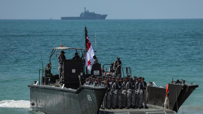 Smoke rises from an amphibious assault vehicles (AAV) participating in an amphibious assault exercise as part of the 