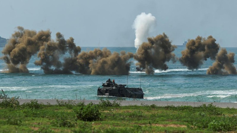 Smoke rises from an amphibious assault vehicles (AAV) participating in an amphibious assault exercise as part of the 
