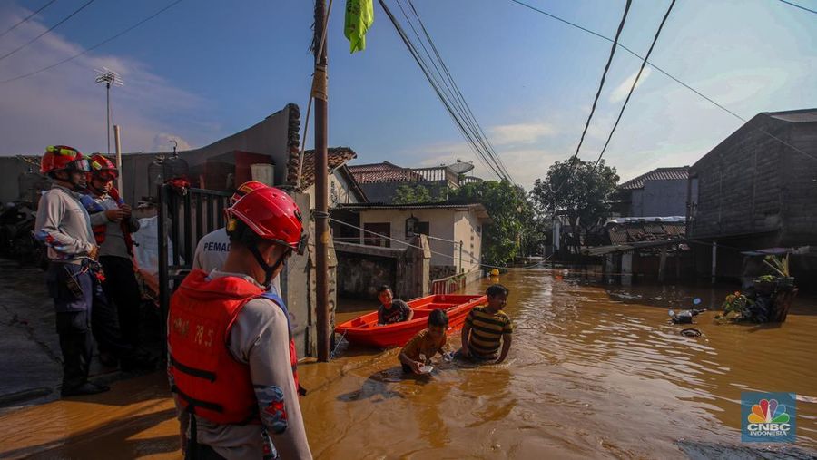 Warga beraktivitas saat banjir melanda kawasan Pejaten Timur, Pasar Minggu di Jakarta, Senin (3/3/2025). (CNBC Indonesia/Faisal Rahman)