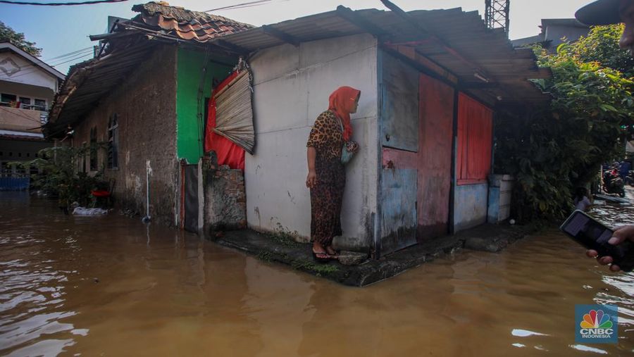 Warga beraktivitas saat banjir melanda kawasan Pejaten Timur, Pasar Minggu di Jakarta, Senin (3/3/2025). (CNBC Indonesia/Faisal Rahman)