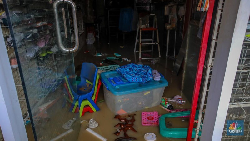 Warga melintasi banjir yang melanda Perumahan Villa Nusa Indah 1, Kecamatan Gunung Putri, Kabupaten Bogor, Jawa Barat, Selasa (4/3/2025). (վ/Faisal Rahman)