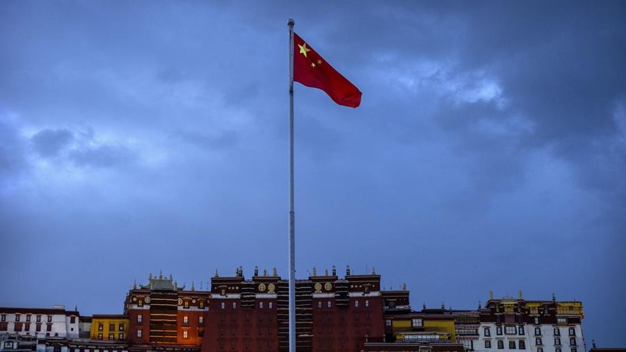 FILE- The Chinese flag flies at a plaza near the Potala Palace in Lhasa in western China's Tibet Autonomous Region, June 1, 2021, as seen during a government organized visit for foreign journalists. (AP Photo/Mark Schiefelbein, File)