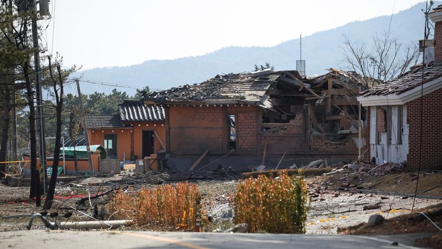 Officials stand near damaged buildings after South Korea's Air Force said that Mk82 bombs fell from a KF-16 jet outside the shooting range during joint live-fire exercises near the demilitarized zone separating two Koreas in Pocheon, South Korea, March 6, 2025. REUTERS/Kim Hong-Ji