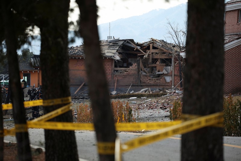 SOUTHKOREA-BLAST/ Officials stand near damaged buildings after South Korea's Air Force said that Mk82 bombs fell from a KF-16 jet outside the shooting range during joint live-fire exercises near the demilitarized zone separating two Koreas in Pocheon, South Korea, March 6, 2025. REUTERS/Kim Hong-Ji