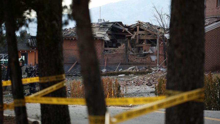 Officials stand near damaged buildings after South Korea's Air Force said that Mk82 bombs fell from a KF-16 jet outside the shooting range during joint live-fire exercises near the demilitarized zone separating two Koreas in Pocheon, South Korea, March 6, 2025. REUTERS/Kim Hong-Ji