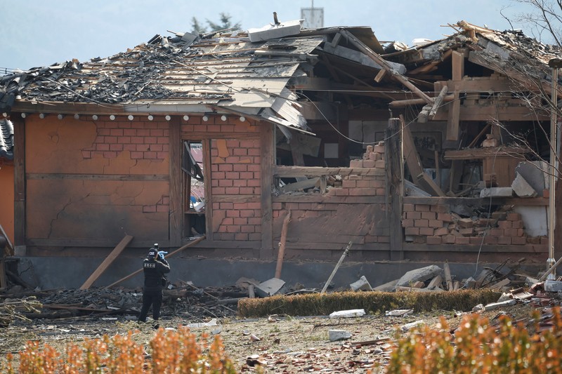 SOUTHKOREA-BLAST/ Officials stand near damaged buildings after South Korea's Air Force said that Mk82 bombs fell from a KF-16 jet outside the shooting range during joint live-fire exercises near the demilitarized zone separating two Koreas in Pocheon, South Korea, March 6, 2025. REUTERS/Kim Hong-Ji