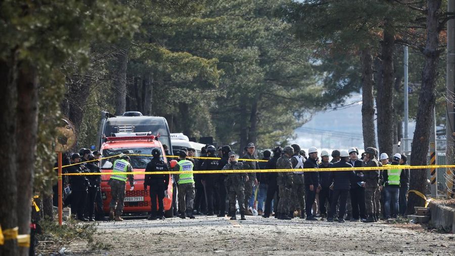 Officials stand near damaged buildings after South Korea's Air Force said that Mk82 bombs fell from a KF-16 jet outside the shooting range during joint live-fire exercises near the demilitarized zone separating two Koreas in Pocheon, South Korea, March 6, 2025. REUTERS/Kim Hong-Ji