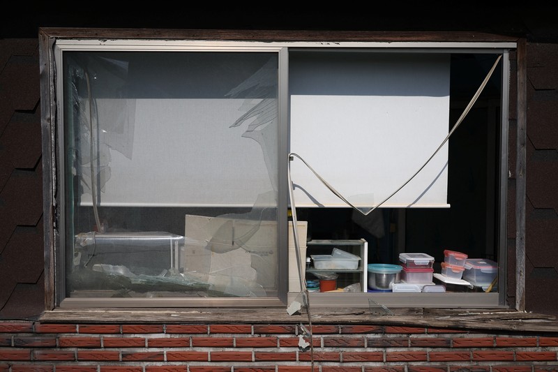 SOUTHKOREA-BLAST/ Officials stand near damaged buildings after South Korea's Air Force said that Mk82 bombs fell from a KF-16 jet outside the shooting range during joint live-fire exercises near the demilitarized zone separating two Koreas in Pocheon, South Korea, March 6, 2025. REUTERS/Kim Hong-Ji