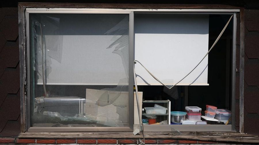 Officials stand near damaged buildings after South Korea's Air Force said that Mk82 bombs fell from a KF-16 jet outside the shooting range during joint live-fire exercises near the demilitarized zone separating two Koreas in Pocheon, South Korea, March 6, 2025. REUTERS/Kim Hong-Ji