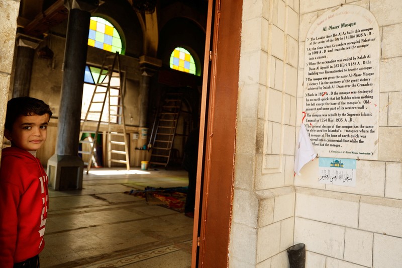 Seorang pria Palestina berdiri di pintu masuk masjid sehari setelah tentara Israel membakar masjid Al-Nasser di Nablus, di tengah serangan Tepi Barat, 8 Maret 2025. Seorang pria Palestina berdiri di pintu masuk masjid sehari setelah tentara Israel membakar masjid Al-Nasser di Nablus, di tengah serangan Tepi Barat, 8 Maret 2025. (REUTERS/Raneen Sawafta)