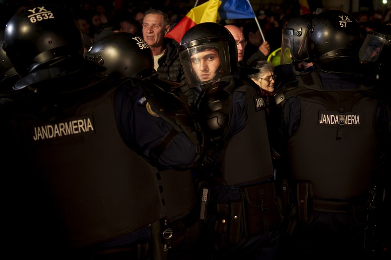 Pendukung kandidat sayap kanan Calin Georgescu berhadapan dengan polisi anti huru hara di luar biro pemilihan pusat Rumania, setelah penolakan pencalonannya untuk pemilihan ulang presiden pada bulan Mei, di Bukares, Rumania, 9 Maret 2025. Pendukung kandidat sayap kanan Calin Georgescu berhadapan dengan polisi anti huru hara di luar biro pemilihan pusat Rumania, setelah penolakan pencalonannya untuk pemilihan ulang presiden pada bulan Mei, di Bukares, Rumania, 9 Maret 2025. (Inquam Photos/George Calin via REUTERS)