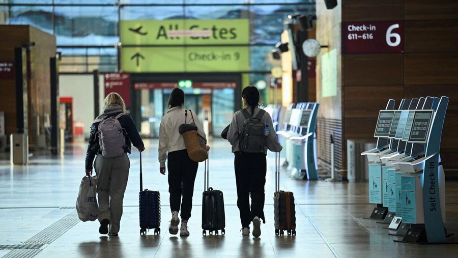 Penumpang berjalan melewati kios check-in mandiri di terminal keberangkatan selama aksi mogok 24 jam di bandara Berlin yang diserukan oleh serikat pekerja Jerman Verdi akibat perselisihan upah di Berlin, Jerman, 10 Maret 2025. (REUTERS/Annegret Hilse)