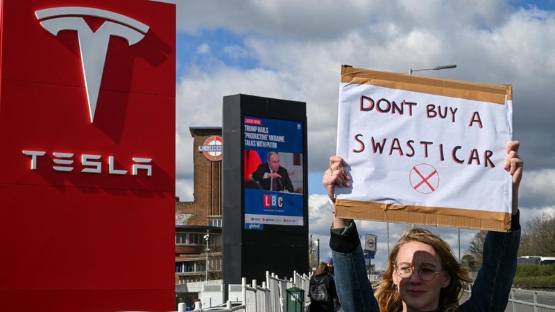 People protest against Tesla and its CEO Elon Musk outside a Tesla store in New York City, U.S., March 15, 2025. REUTERS/Jeenah Moon