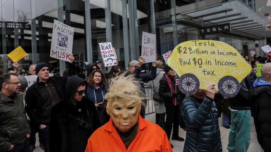 People protest against Tesla and its CEO Elon Musk outside a Tesla store in New York City, U.S., March 15, 2025. REUTERS/Jeenah Moon