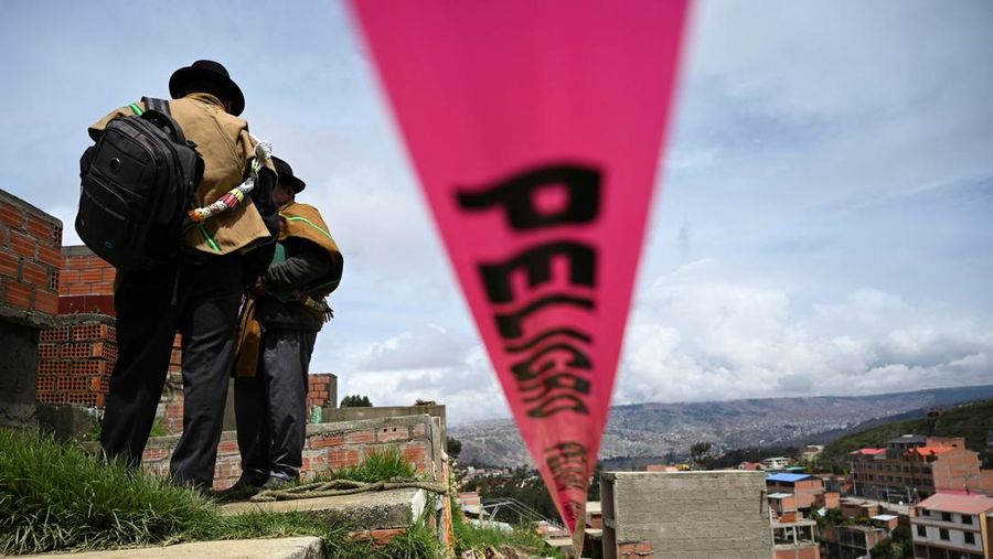 Orang-orang menemukan jenazah kerabat mereka setelah tanah longsor di pemakaman rahasia Ovejuyo yang disebabkan oleh hujan, di kotamadya Palca, Bolivia, 17 Maret 2025. (REUTERS/Claudia Morales)