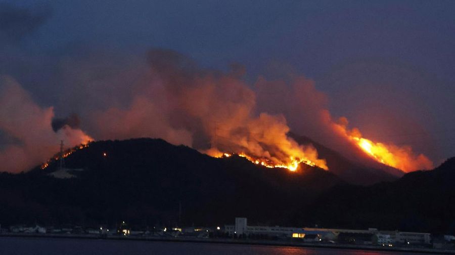 Japan Wildfires Smoke rises from a forest in Okayama, western Japan Sunday, March 23, 2025. (Kyodo News via AP)