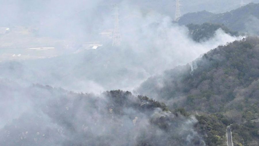 Japan Wildfires Smoke rises from a forest in Okayama, western Japan Sunday, March 23, 2025. (Kyodo News via AP)