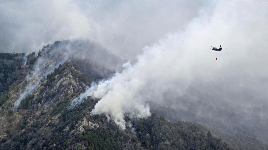 Japan Wildfires Smoke rises from a forest in Okayama, western Japan Sunday, March 23, 2025. (Kyodo News via AP)